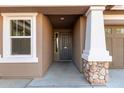 Front entrance with stone pillar and shaded walkway at 3254 N Park St, Buckeye, AZ 85396