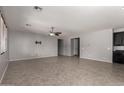 Spacious living room featuring neutral paint, tile floors, and a ceiling fan at 3254 N Park St, Buckeye, AZ 85396