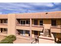 Close-up of a well-maintained apartment building, featuring clean lines, balconies and easy access with exterior stairs at 3601 W Tierra Buena Ln # 233, Phoenix, AZ 85053