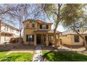 Inviting two-story home featuring a charming front porch, neutral color palette and drought tolerant landscaping at 3840 E Yeager Dr, Gilbert, AZ 85295