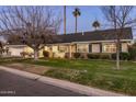 A charming home showcasing a lush front yard, covered porch, and appealing architectural details at 4111 N 52Nd St, Phoenix, AZ 85018