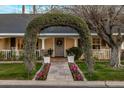 Beautiful front entrance with a lush, floral-covered archway leading to the welcoming front door at 4111 N 52Nd St, Phoenix, AZ 85018