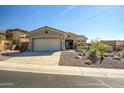 Charming single-story home with desert landscaping, a two-car garage, and a cozy gated front patio at 41921 N Crooked Stick Rd, Anthem, AZ 85086