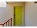 Inviting front entrance featuring a vibrant door, textured wall, and iron railing at 4201 E Camelback Rd # 34, Phoenix, AZ 85018