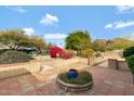 Inviting backyard patio with brick accents and desert landscaping, perfect for outdoor entertaining at 4349 E Stanford Dr, Phoenix, AZ 85018