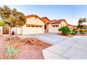 Charming single-story home with a three-car garage, desert landscaping, and a stone accent entry at 4545 S Ellesmere St, Gilbert, AZ 85297