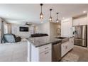 Open-concept kitchen with granite countertops, stainless steel appliances, and island perfect for entertaining at 4593 W Bush Bean Way, San Tan Valley, AZ 85144