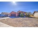 Single-story home with low-maintenance desert landscaping and an attached two-car garage at 5071 W Warren Dr, Casa Grande, AZ 85194