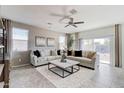 Inviting living room featuring plush sofas, stylish decor, and a sliding glass door to the outside at 5106 E Umber Rd, San Tan Valley, AZ 85143