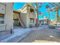 Condominium exterior featuring lush landscaping, mature trees, and inviting walkways at 5335 E Shea Blvd # 2126, Scottsdale, AZ 85254