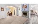 Open-concept living room with a fireplace, adjacent to the dining area; great flow for entertaining at 5462 W Geronimo St, Chandler, AZ 85226