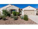 Inviting single-story home boasts low-maintenance desert landscaping and a warm, neutral color palette at 6656 W Springfield Way, Florence, AZ 85132