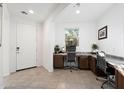 Bright home office with built-in desks, providing ample workspace and a serene view from the window at 678 E Cobble Stone Dr, Queen Creek, AZ 85140