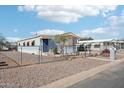 Cozy single-story home featuring a fenced yard and desert landscaping offering easy maintenance at 690 S 92Nd Pl, Mesa, AZ 85208