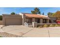 Charming single-story home with a red tile roof, attached garage and spacious driveway at 8544 E San Lorenzo Dr, Scottsdale, AZ 85258