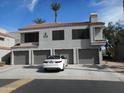 Exterior shot of a two-story townhome featuring a multi-car garage, white car parked in the driveway and red tile roof at 10115 E Mountain View Rd # 1119, Scottsdale, AZ 85258