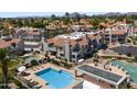 Aerial view of a community pool, spa, and grill area with well-maintained landscaping at 10115 E Mountain View Rd # 1119, Scottsdale, AZ 85258