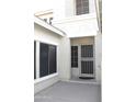 Inviting front entryway with a security door and a sunny, neutral-colored facade and trimmed windows at 10343 E Jacob Ave, Mesa, AZ 85209