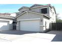 Beautiful two-story home with two-car garage and neutral exterior is complemented by a well-maintained front yard at 10343 E Jacob Ave, Mesa, AZ 85209