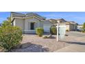 Charming single Gathering home on a sunny day with desert landscaping and sidewalk at 10343 E Jacob Ave, Mesa, AZ 85209