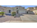 Charming single Gathering home featuring a 2-car garage and low maintenance desert landscaping at 10343 E Jacob Ave, Mesa, AZ 85209