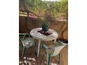 Cozy balcony seating with a small table and chairs, offering a relaxing outdoor space with climbing vegetation and flowers at 10410 N Cave Creek Rd # 1103, Phoenix, AZ 85020