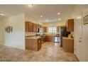 Functional kitchen with stainless steel appliances, wood cabinets, granite countertops, and a tile floor at 1066 E Sourwood Dr, Gilbert, AZ 85298