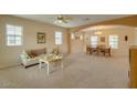 Inviting open-concept living room and dining area with neutral tones, large windows, and lots of natural light at 1066 E Sourwood Dr, Gilbert, AZ 85298