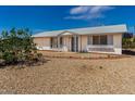 Single-story home with a xeriscaped front yard, covered entryway, and view of the blue sky at 10846 W Sun City Blvd, Sun City, AZ 85351