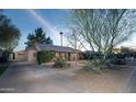 A charming home featuring a lush green lawn and spacious driveway at 1261 E Edgemont Ave, Phoenix, AZ 85006