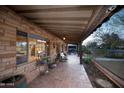 Expansive covered patio with brick flooring, plenty of seating, and lush plants at 1261 E Edgemont Ave, Phoenix, AZ 85006