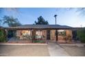 Inviting front porch with brick accents and cozy seating area, perfect for relaxing at 1261 E Edgemont Ave, Phoenix, AZ 85006