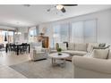 Bright living area with neutral furniture, large windows, and an open floor plan at 14254 W Cottontail Ln, Surprise, AZ 85387