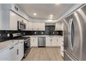 Modern kitchen with sleek white cabinetry, stainless steel appliances, and a stylish backsplash at 148 N Glenview --, Mesa, AZ 85213