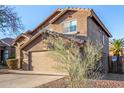 Home featuring an attached two-car garage and desert landscaping at 15466 W Shangri La Rd, Surprise, AZ 85379