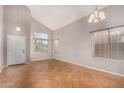 Bright living room featuring tile flooring, high ceilings, and natural light at 15466 W Shangri La Rd, Surprise, AZ 85379