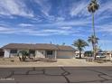 Inviting single-story home featuring a desert landscape, two-car garage, and a well-maintained yard at 17626 N Buntline Dr, Sun City West, AZ 85375