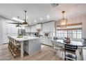 Modern kitchen with a large island, stainless steel appliances, and stylish pendant lighting fixtures at 1837 E Coolidge St, Phoenix, AZ 85016