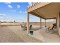 Relaxing covered patio with outdoor furniture and a spacious gravel backyard, perfect for entertaining at 24108 N Nectar Ave, Florence, AZ 85132