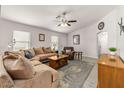 Comfortable living room with a large sectional sofa, natural light, and stylish decor at 24108 N Nectar Ave, Florence, AZ 85132