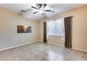 Neutral bedroom featuring a ceiling fan, tile floors and large window at 2571 E Balsam Ct, Chandler, AZ 85286