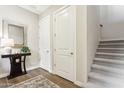 Bright entryway featuring tiled floors, a staircase, and a decorative table with a mirror at 27000 N Alma School Pkwy # 2019, Scottsdale, AZ 85262