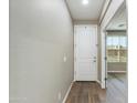 Inviting hallway with wood-look floors and a white front door, leading into a bright living space with natural light at 287 N Jesse St, Chandler, AZ 85225