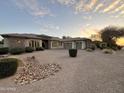 Beautiful single-story home featuring a three-car garage, desert landscaping, and decorative rock accents at 2879 E Portola Valley Ct, Gilbert, AZ 85297