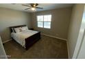 A bedroom with a queen bed, window and carpet at 29573 W Mitchell Ave, Buckeye, AZ 85396