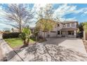 Beautiful two-story home showcasing a well-maintained front yard, large driveway, and three-car garage at 337 E Clairidge Dr, San Tan Valley, AZ 85143