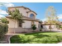 Beautiful home with lush green lawn, mature shade trees, and well-maintained landscaping at 337 E Clairidge Dr, San Tan Valley, AZ 85143