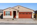 Beautiful single-Gathering home with well maintained front yard, complemented by the striking orange garage door and shutters at 37056 W Prado St, Maricopa, AZ 85138