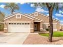 Inviting single-Gathering home with a two-car garage, manicured landscaping, and a welcoming entrance at 39242 N Luke Cir, San Tan Valley, AZ 85140