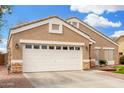 Well-kept home with a spacious two-car garage, and low maintenance desert landscaping at 39242 N Luke Cir, San Tan Valley, AZ 85140